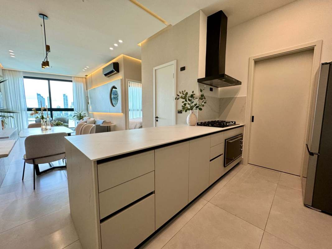 Contemporary living and dining area with marble floors, open kitchen, large windows overlooking ocean views at PH Aquapoint Panama