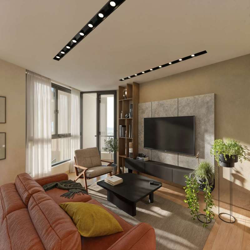 Bright living area with rust sofa, flat-screen TV, large window and indoor plants at LOV Panama