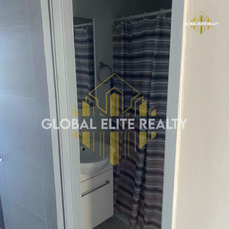 Bedroom features window with light, tile flooring, split AC, and closet in Carrasquilla rental