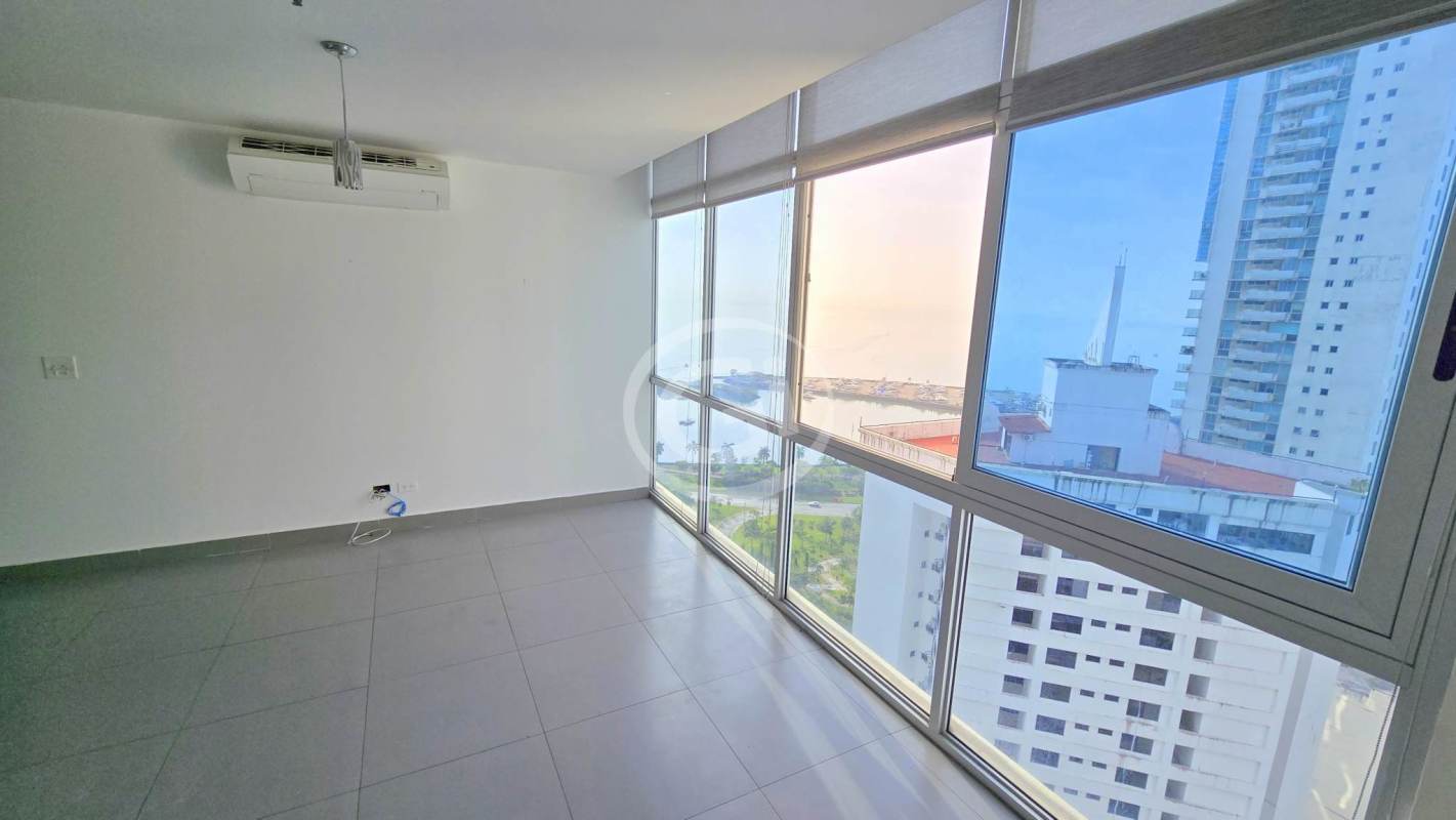 Bedroom with large floor-to-ceiling windows featuring ocean and skyline views at PH Colores de Bella Vista