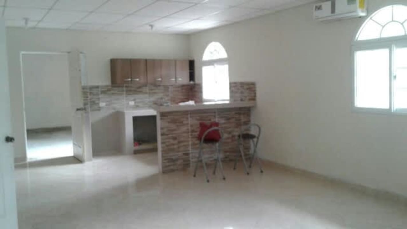 Covered parking garage with metal door and fenced yard in Quebrada Ancha Chilibre Panama