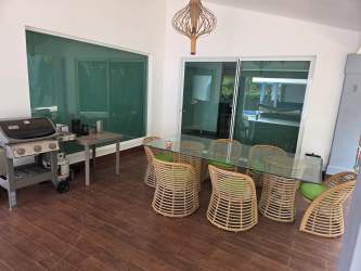 Spacious living room with sectional sofa, terrace access Punta Barco Village Panama rental home