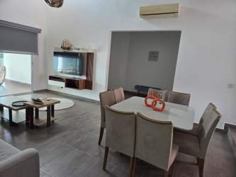 Modern kitchen with island seating, granite counters and appliances in Punta Barco Village luxury villa