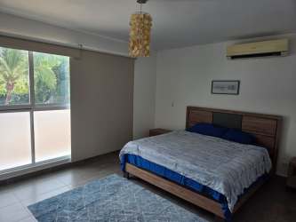 Mediterranean style house with driveway palm trees and carport in Punta Barco Panama luxury rental