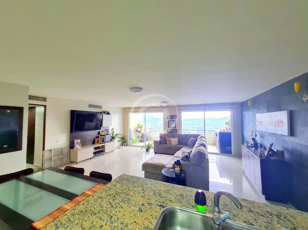 Modern open kitchen with granite countertops appliances and breakfast bar in Altamira Gardens Panama City