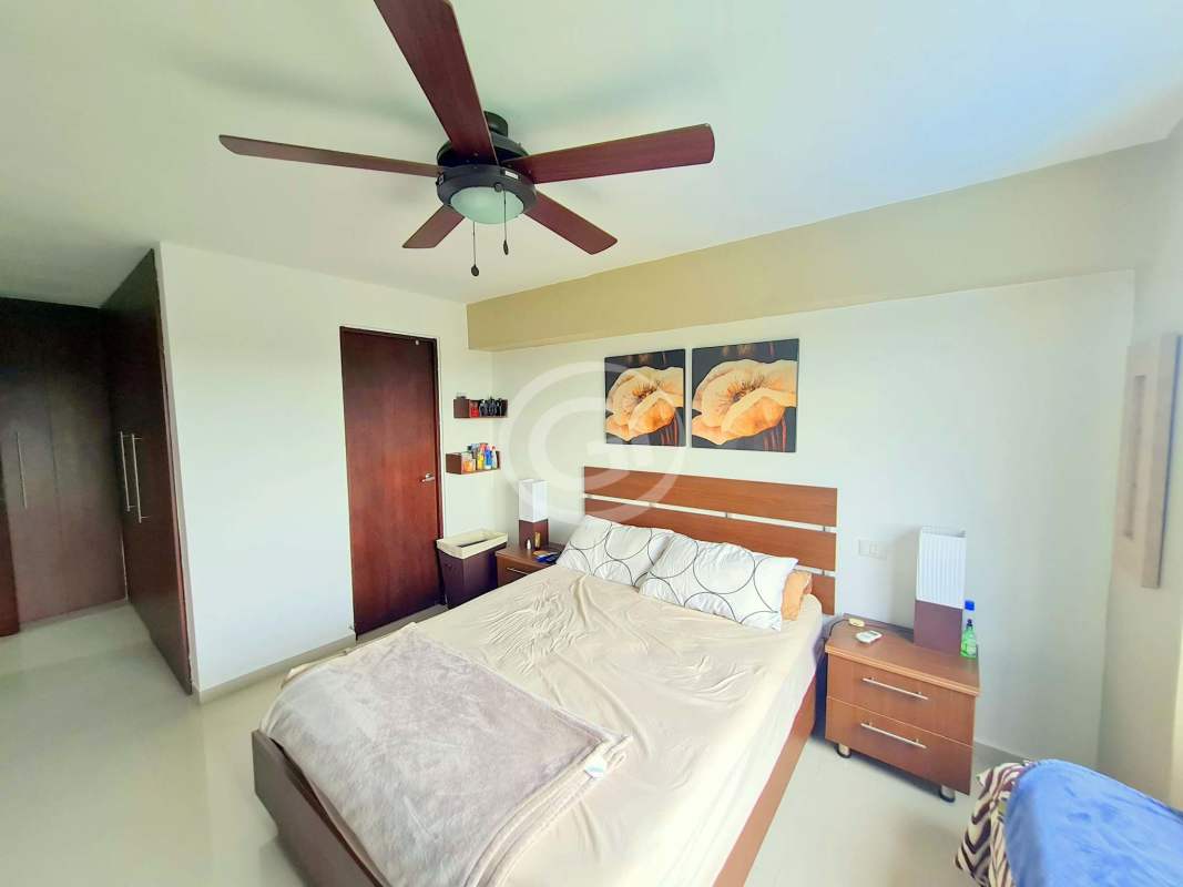 Furnished master bedroom with large window, ceiling fan and AC in Altamira Gardens Ancón Panama City