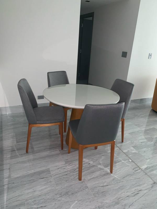 Modern dining space with round table, grey chairs, marble tiles at PH Nuovo Armani Casa Avenida Balboa Panama City