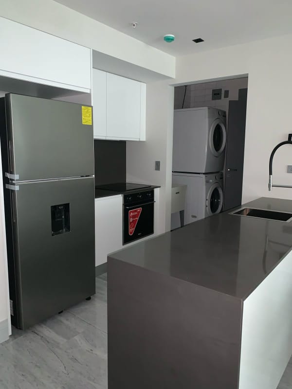 Contemporary kitchen with stainless steel fridge, island, washer/dryer, PH Nuovo Armani Casa Avenida Balboa