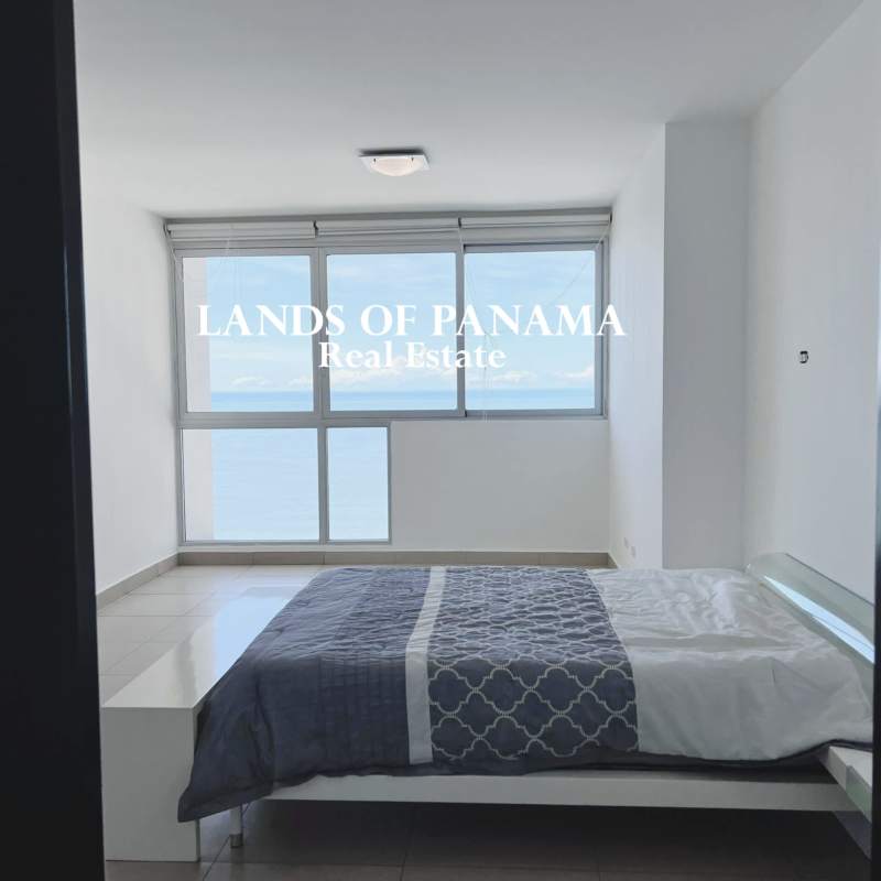 Spacious living room with oceanfront windows and balcony access PH Oceanaire Panama