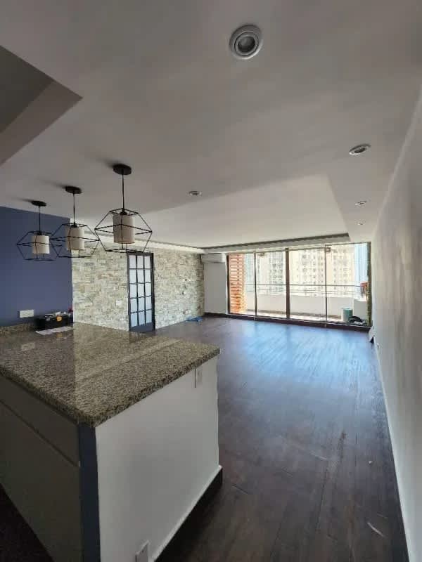 Apartment balcony with mosaic tile floor, green wall, and skyline view PH Pacific Wind Punta Paitilla Panama