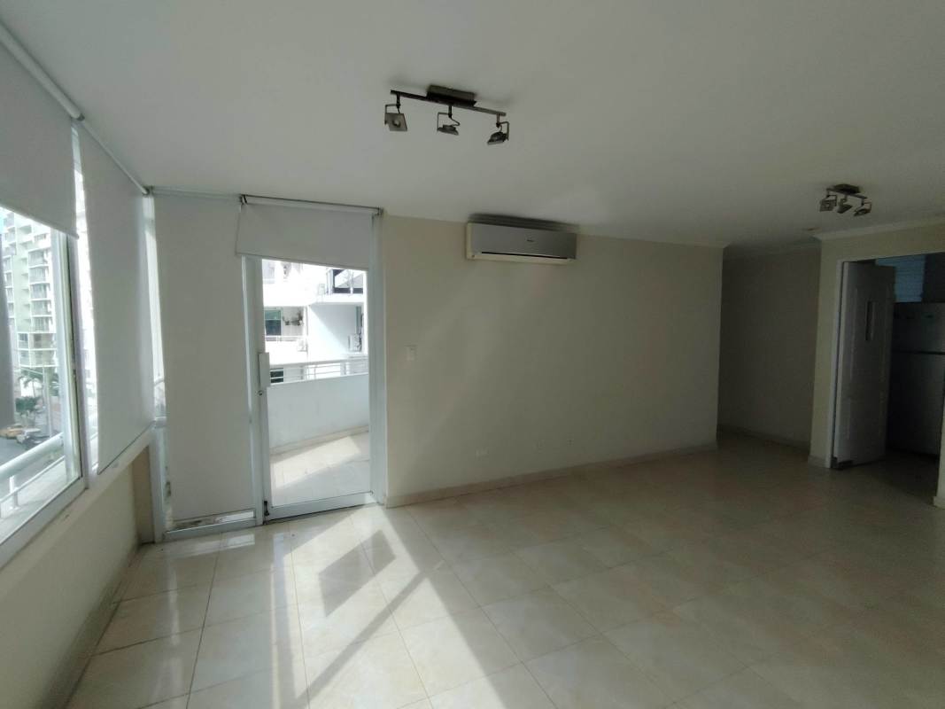 Kitchen with black granite countertops, upper wood cabinets, built-in oven in PH El Mare Edison Park Panama
