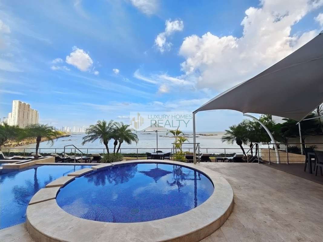 Elegant master bedroom with balcony access, ocean view, modern décor in PH Oceanaire, Punta Pacífica.
