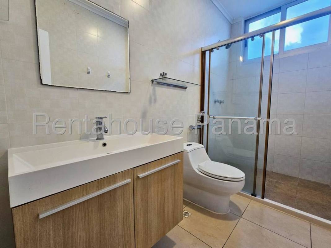 Bedroom with tile flooring and floor-to-ceiling window with ocean view Punta Pacifica Panama