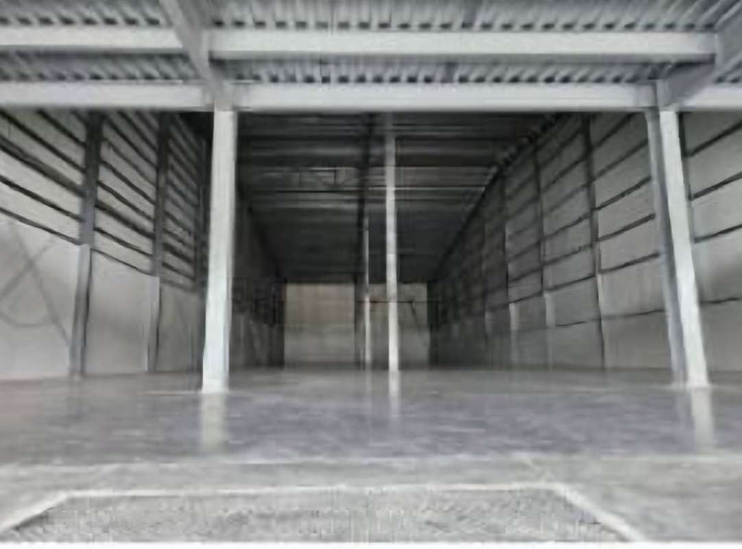 Empty industrial warehouse interior with high roof metal siding concrete floors Panama City