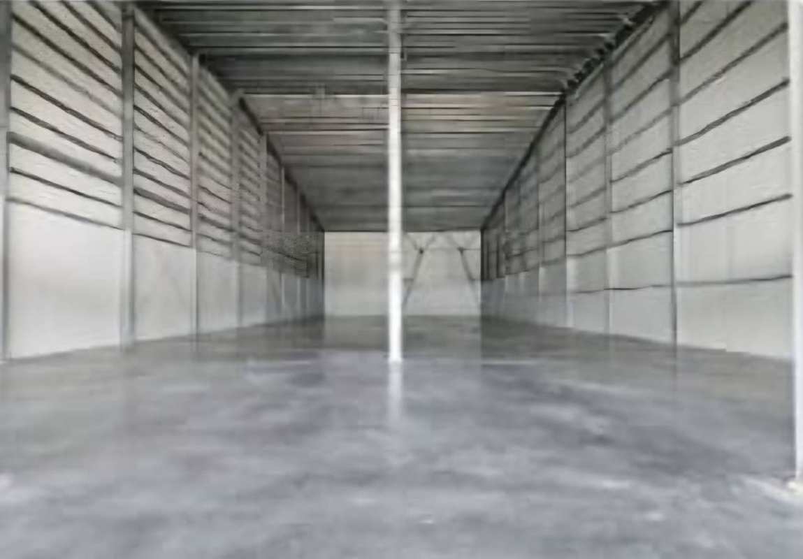 Interior of vacant warehouse with metal roof high ceiling concrete floor in Tumba Muerto Panama City