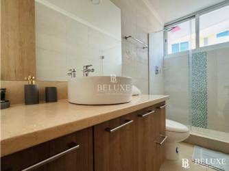 Spacious master bedroom with oceanfront balcony access at Bahia Playa Serena Panama