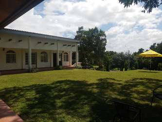 Living room with large windows ceiling fan open plan in San Carlos house rental Panama