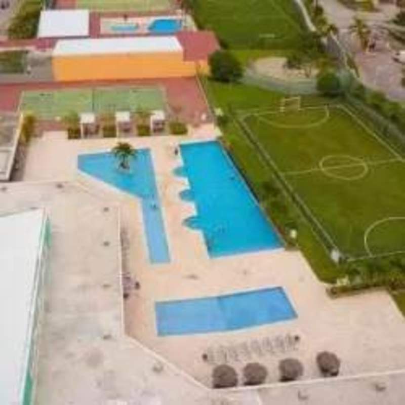 Aerial photo showing swimming pools, tennis courts, sports fields at Brisas del Golf community Panama