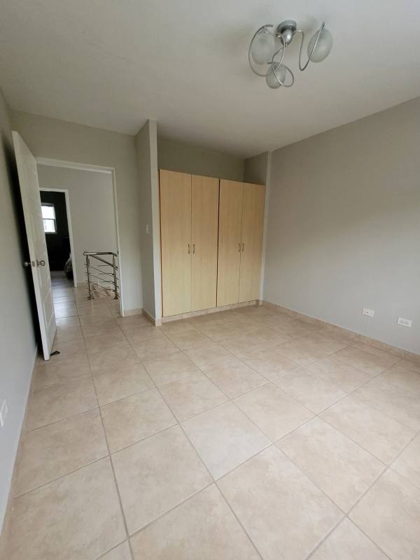 Bedroom with windows, tiled floors, neutral walls in duplex house Brisas del Golf Panama