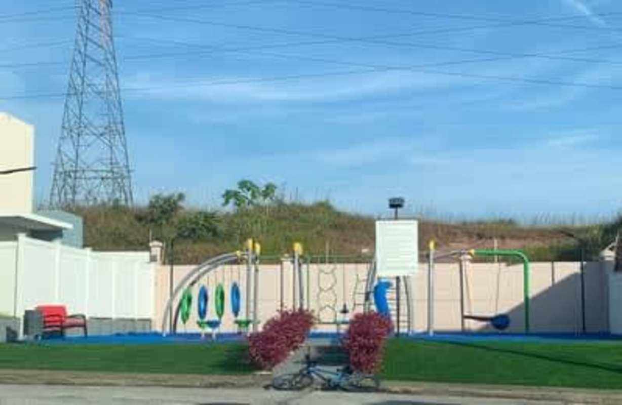 Children's playground with colorful play equipment and benches in residential complex Brisas del Golf Panama
