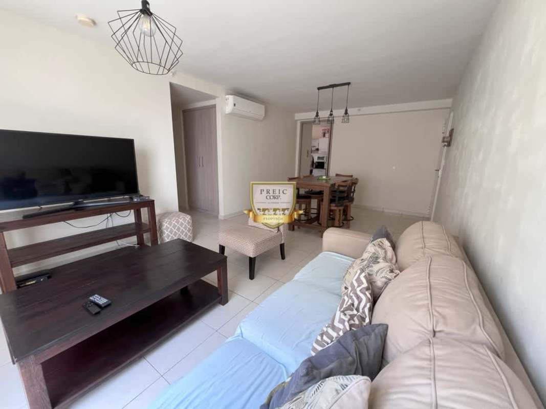 Open living and dining room in furnished apartment PH Versalles Las Acacias Panama with natural light