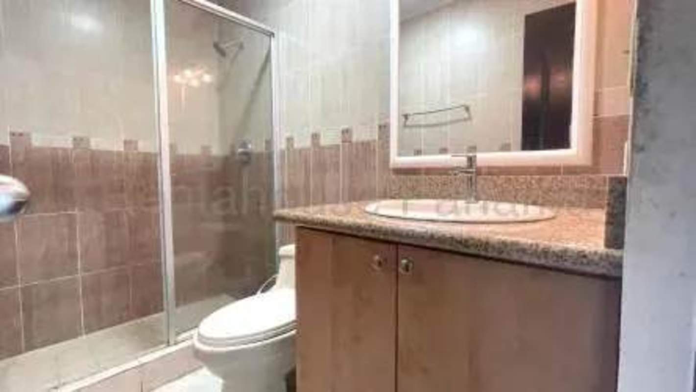 Modern condominium tower with balconies, pool, and terrace in San Francisco Bay Panama