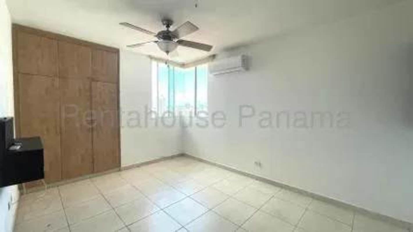 Bedroom with closet space, ceiling fan, tile flooring in PH San Francisco Bay Tower