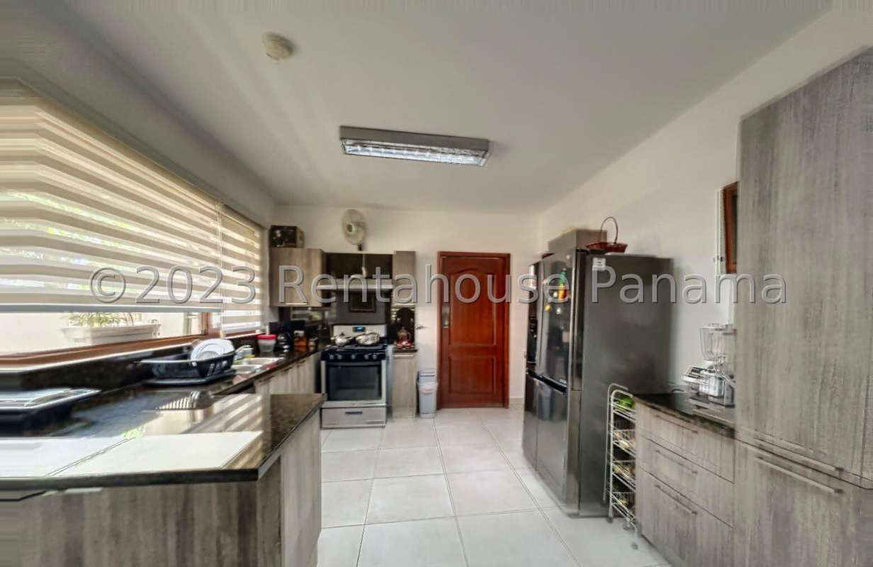 Covered backyard terrace overlooking private garden at Los Senderos house for sale Clayton Panama