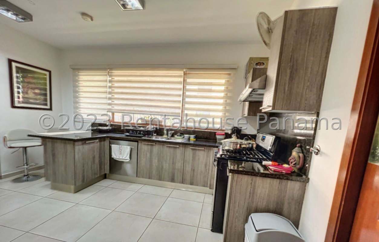 Spacious double-height living room with large windows and tile floors in house for sale at Los Senderos Clayton Panama