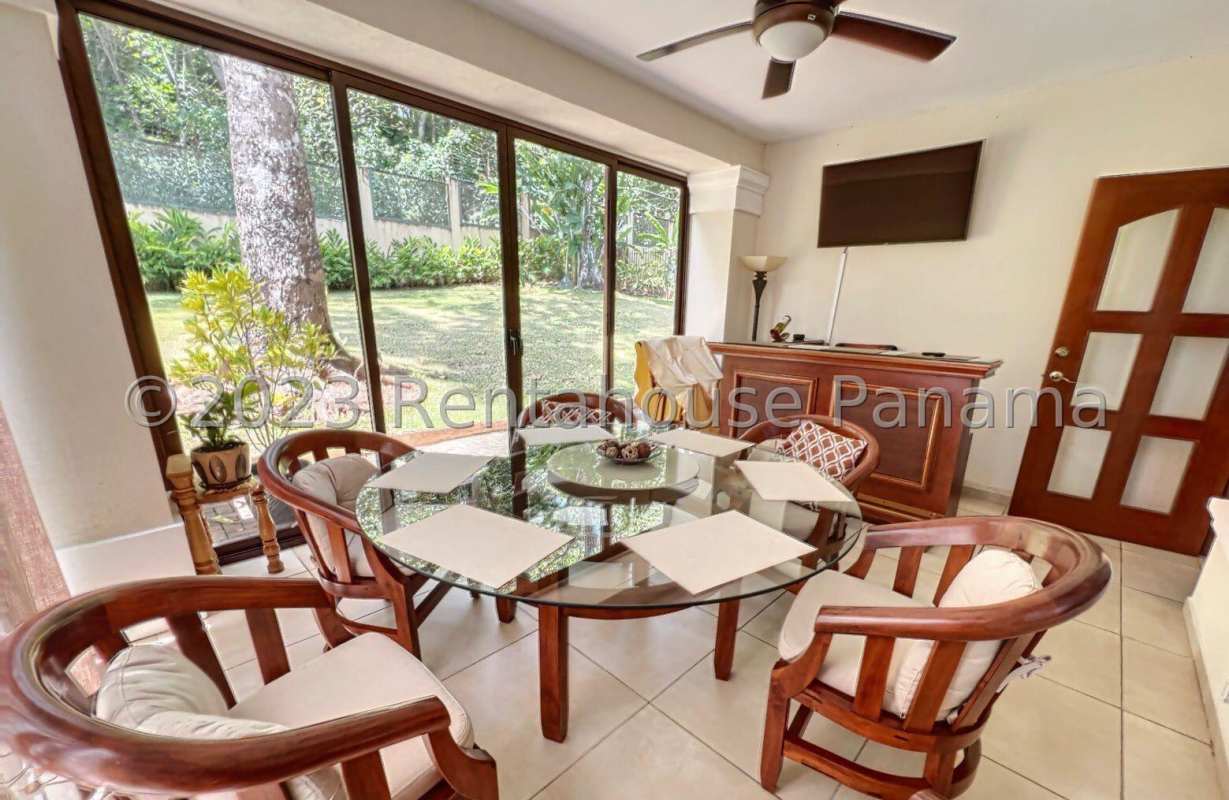 Spacious dining area with family lounge and large windows in house for sale Clayton Panama