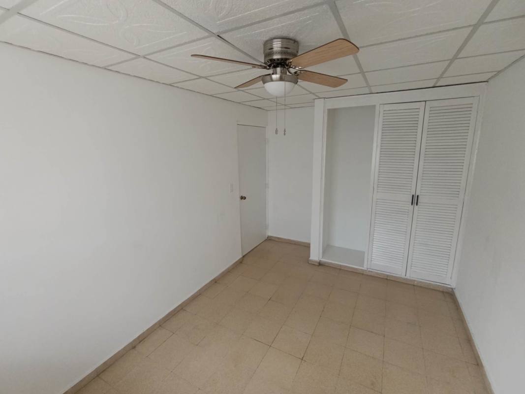 Bedroom with tiled floor, closet, security bars and ceiling fan in Campo Limberg Panama City