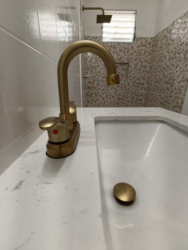 Modern bathroom with marble countertop, gold faucets and walk-in shower for rent Don Bosco Panama