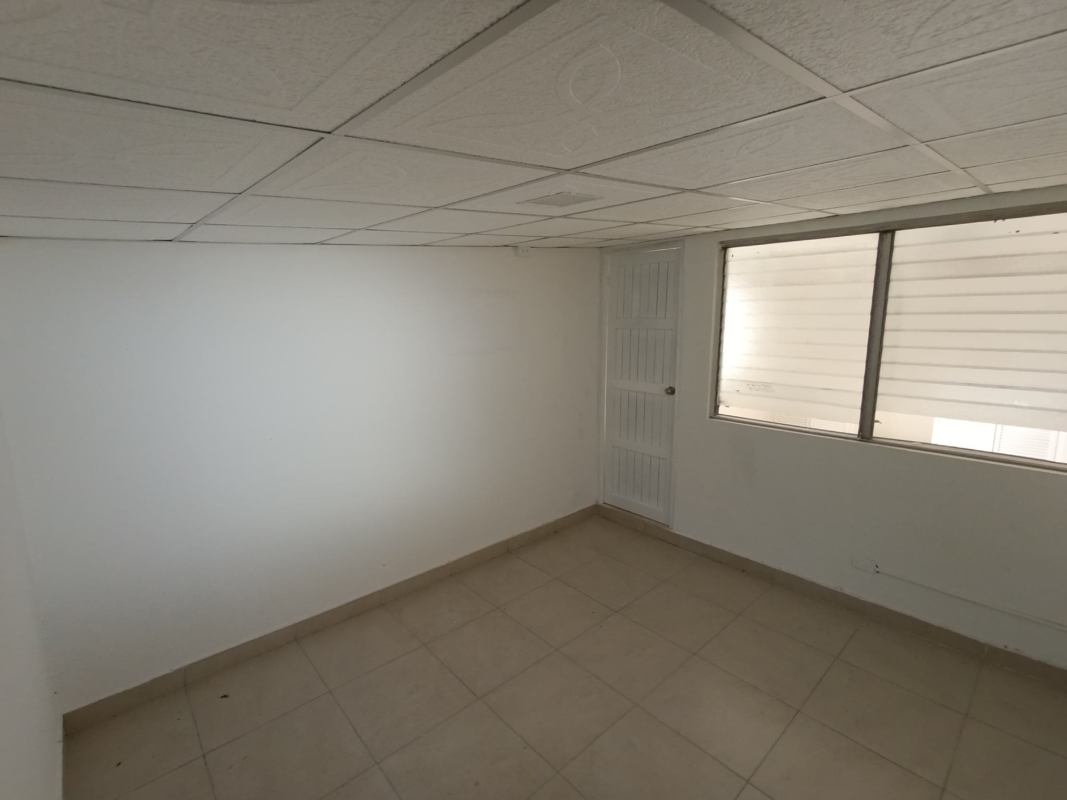Bedroom with large window, built-in closet and ceiling fan Campo Limberg Panama City