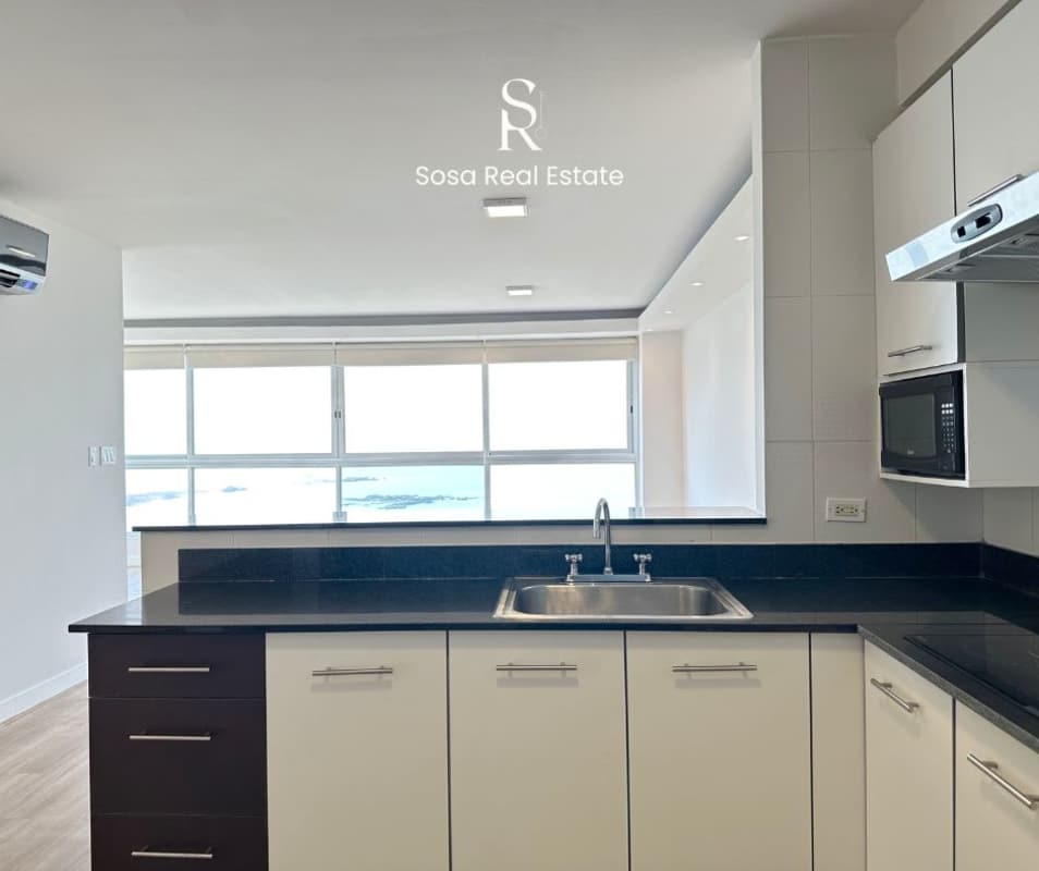 Modern kitchen with granite, appliances and ocean view window BICSA Tower Panama