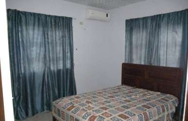 Covered outdoor patio with hammock, potted plants garden fenced backyard David Chiriqui