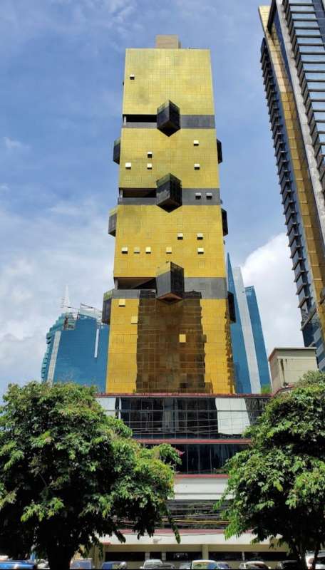Golden skyscraper with black accents geometric shape Obarrio Panama City