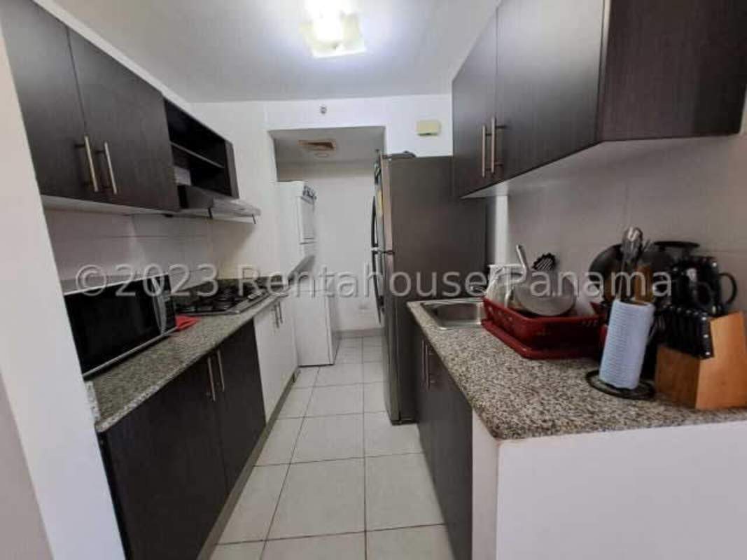 Modern apartment kitchen granite counters stacked washer dryer PH Vía España tower