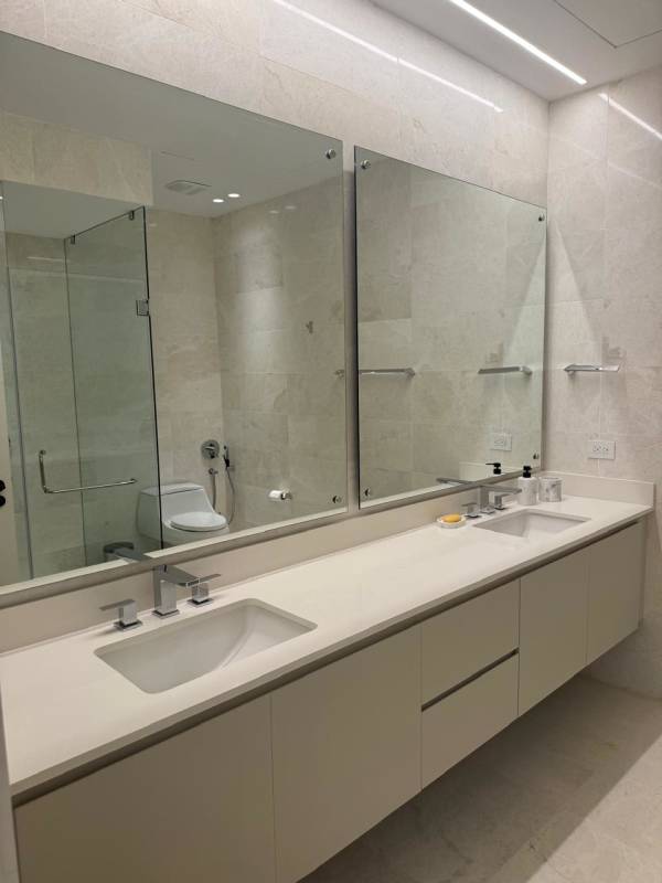Luxury bathroom with stone tiles and glass walk-in shower Ocean Reef Panama