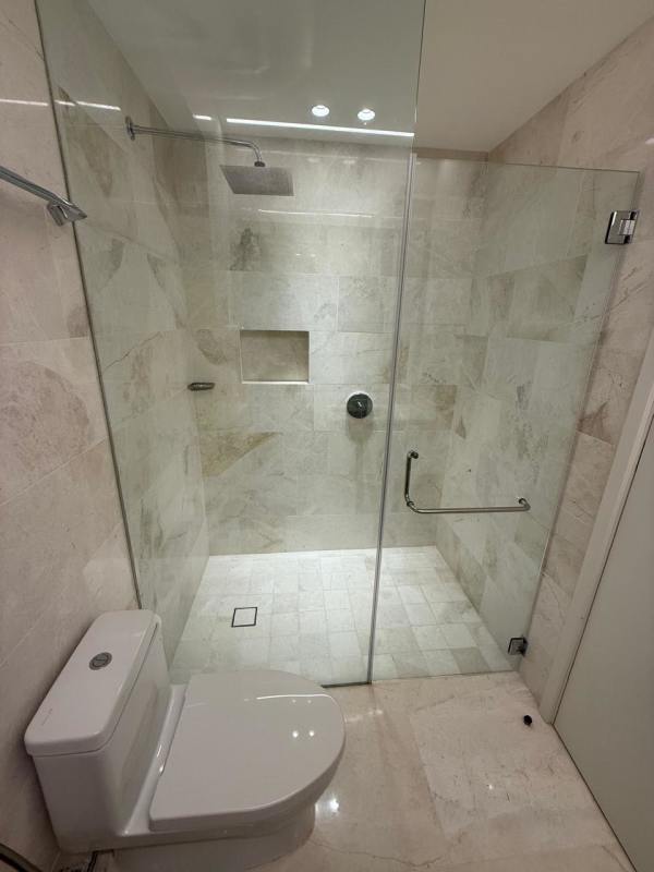 Minimalist modern bathroom with glass shower and beige tiles Ocean Reef Panama