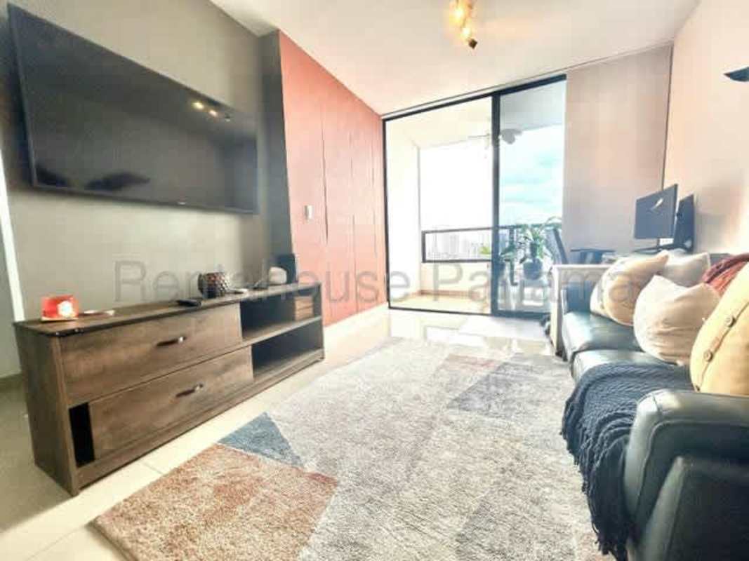 Cozy living room with sofa and sliding glass balcony door in Canvas Tower Panama