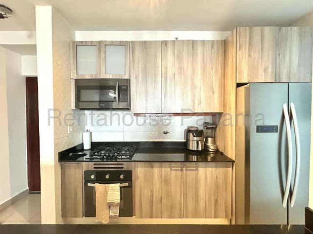 Modern kitchen with wood cabinets granite countertops Canvas Tower Panama