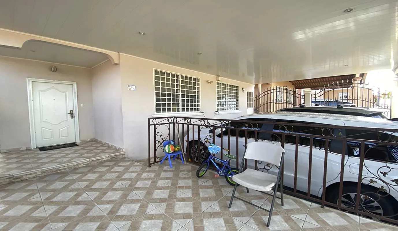 Spacious living room with sectional sofa, dining set, tiled floors in Brisas del Golf Panama family home