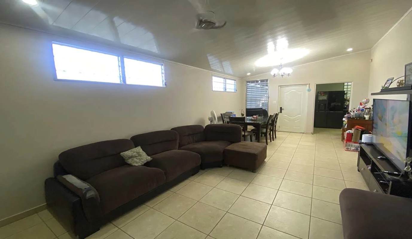 Bright kitchen with granite countertops, white cabinets, tiled floors, window blinds in Brisas del Golf Panama