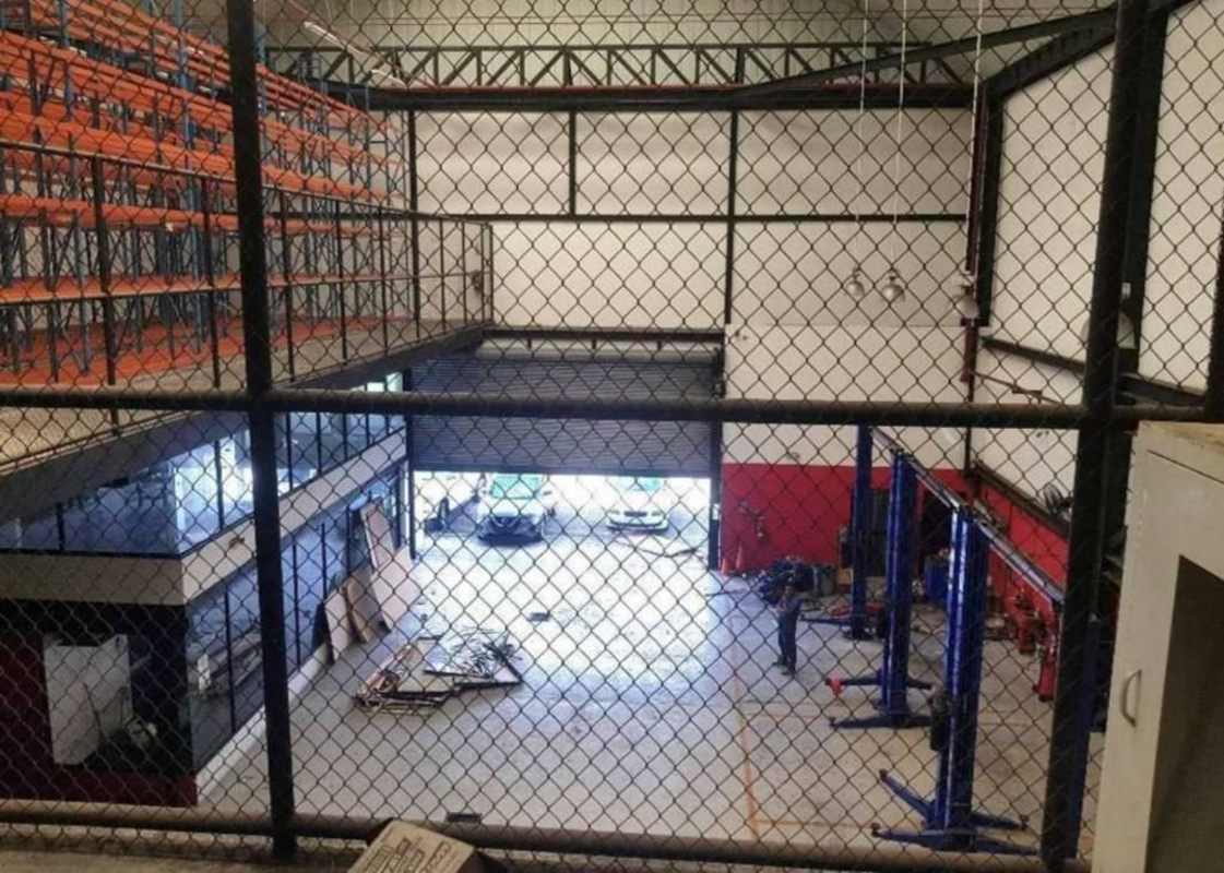 Empty industrial warehouse with orange pallet racks concrete floors Costa del Este Panama