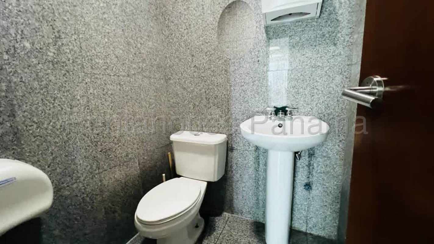 Bathroom with granite wall finish, pedestal sink, and toilet PH CCD Panama City