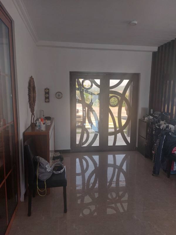 Spacious foyer with double glass doors marble floors Club de Golf Panama luxury house
