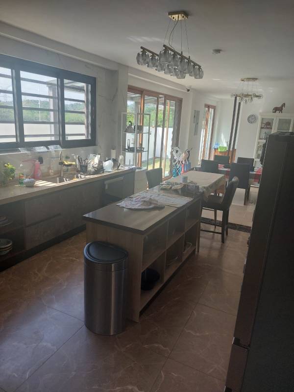 Modern kitchen with island dining area and garden views luxury golf house Panama