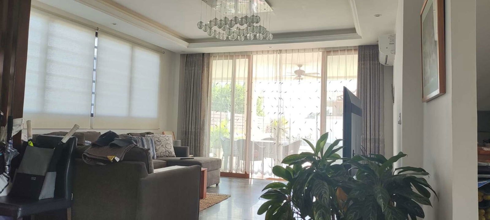 Bright contemporary living room with sliding doors to garden Club de Golf Panama