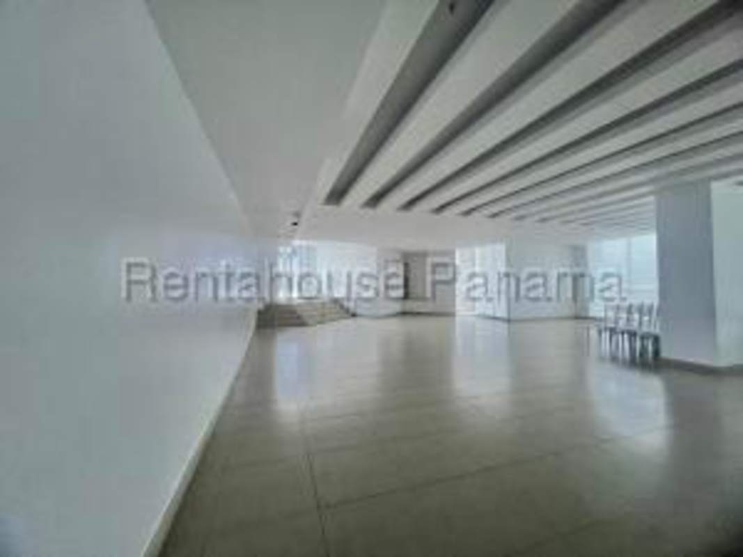 Open space living dining area with balcony access and ocean views at PH Country Club Costa del Este