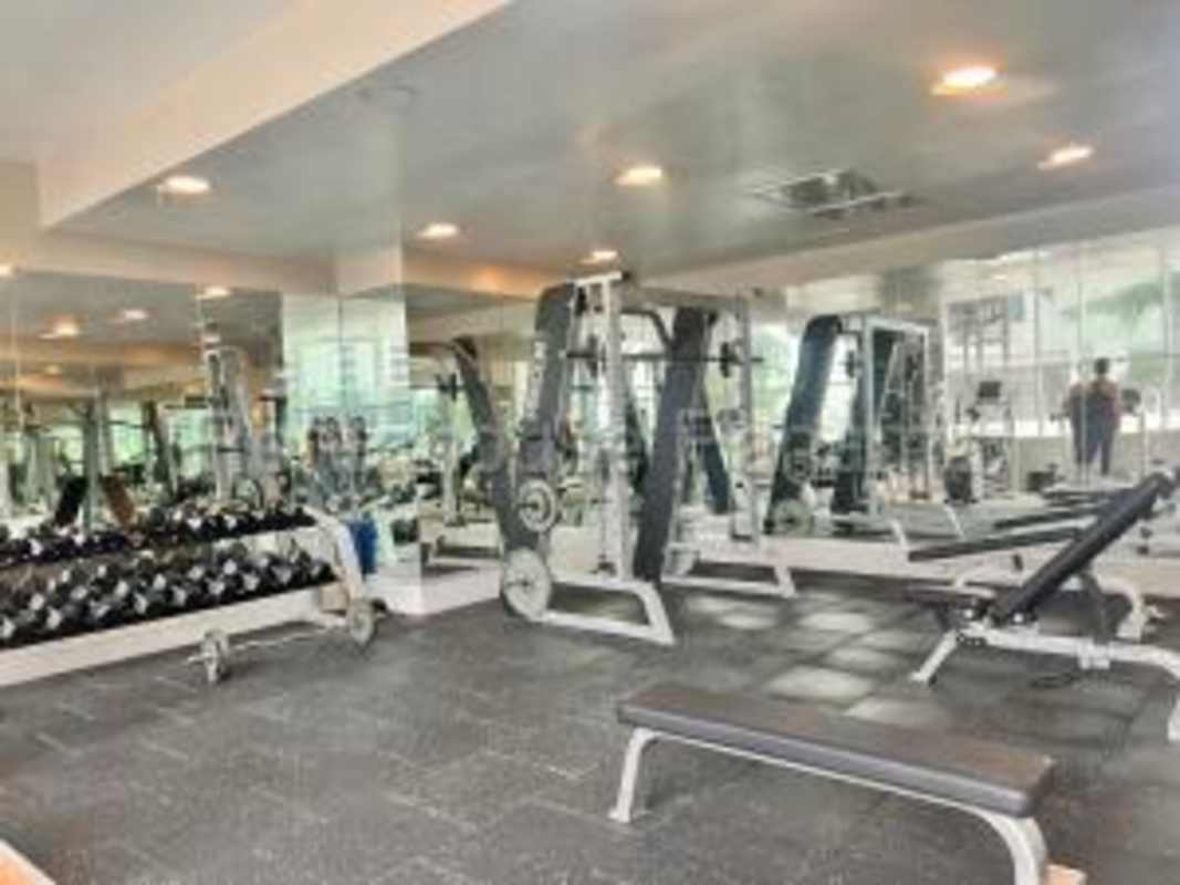 Spacious closed kitchen with granite counters and white cabinetry in PH Country Club Costa del Este